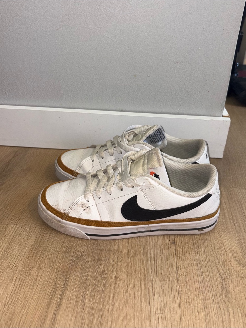 Nike White Low-Top Sneakers with Black Swoosh and Tan Trim